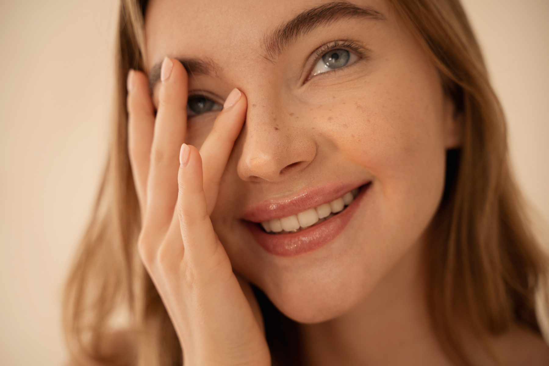 Smiling Woman Touching Her Face