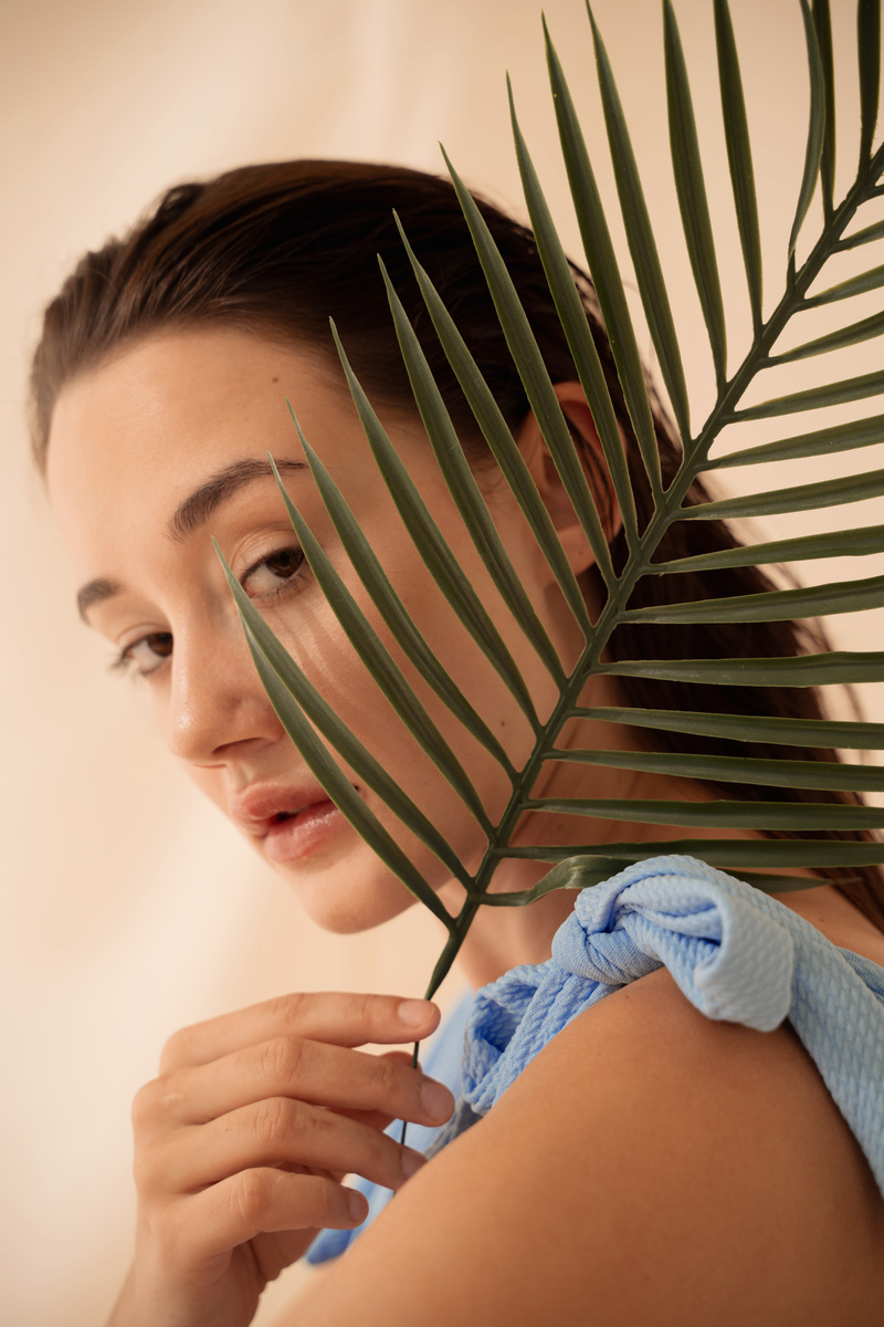 Woman Holding a Palm Leaf